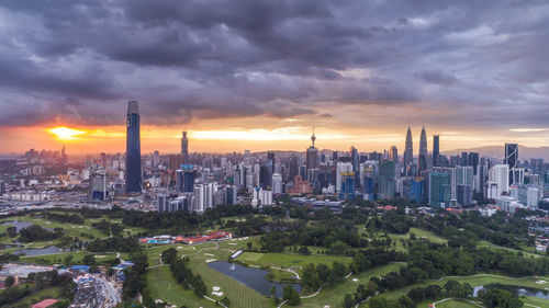 Aerial view of buildings in city during sunset