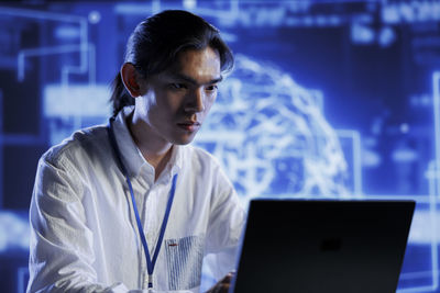 Young woman using laptop at office