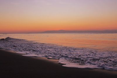 Scenic view of sea against romantic sky at sunset