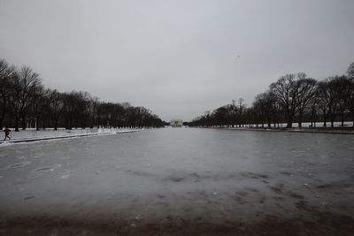 Scenic view of lake against sky during winter