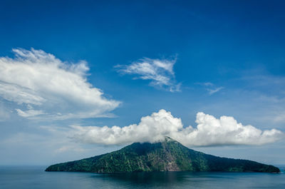 Scenic view of mountains against blue sky