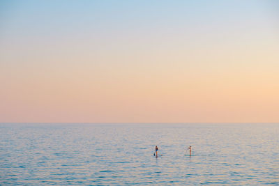 Scenic view of sea against clear sky during sunset