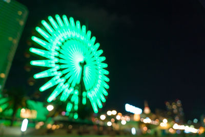 Low angle view of illuminated lights against sky at night