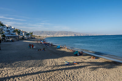 People on beach against sky