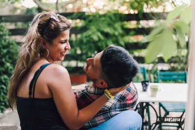 Side view of couple sitting outdoors