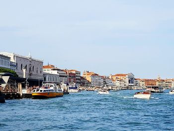 Boats moored on sea against clear sky