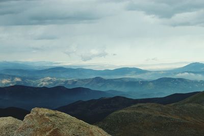 Scenic view of mountains against cloudy sky