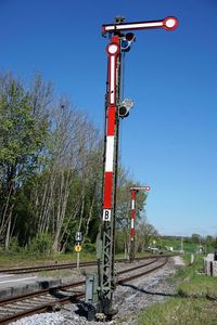 View of railroad tracks against clear blue sky