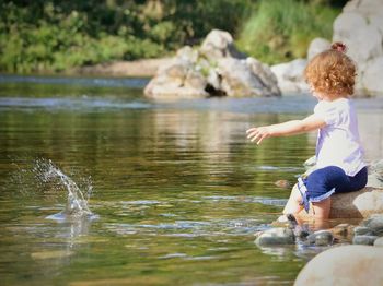 Toddler girl playing on lakeshore