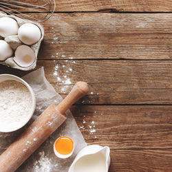 Baking ingredients, kitchen utensils on old wooden background. cooking dough, preparing egg yolk