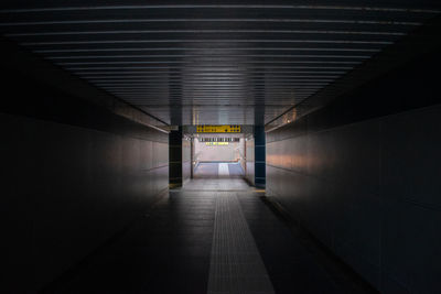 Empty corridor in illuminated building