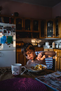 Woman eating food at home