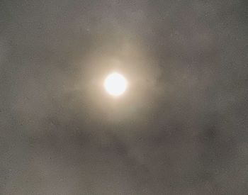 Low angle view of illuminated moon against sky at night