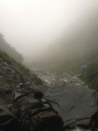 Scenic view of mountains in foggy weather