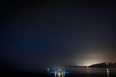 Scenic view of sea against sky at night