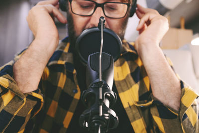 Cropped image of man holding microphone