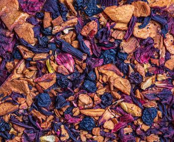 Background of natural fruit tea with hibiscus petals, fruit slices and berries. fruit tea texture
