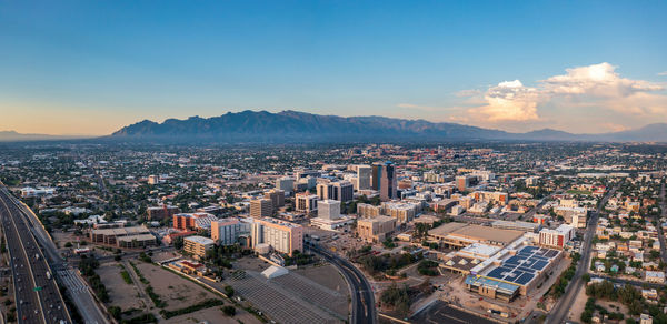 Large panorama of tucson arizona with catalina mountains in distance. evening blue hour.