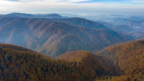 Scenic view of mountains against cloudy sky