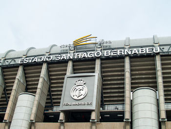 Low angle view of text on building against sky