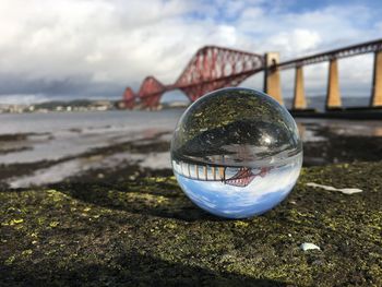 Close-up of crystal ball on beach