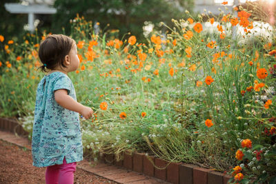 Girl standing by plants