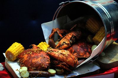 Close-up of crabs in bucket  on table