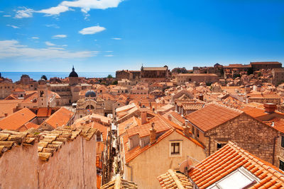 Buildings in city against blue sky