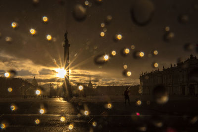 Illuminated city street during rainy season at night