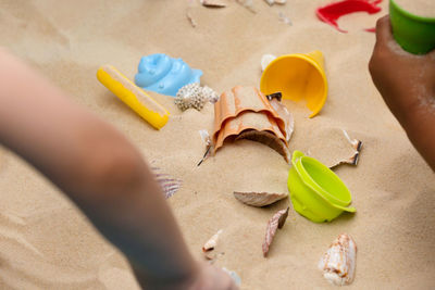 Close-up of hand on sand