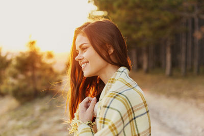 Portrait of young woman standing outdoors