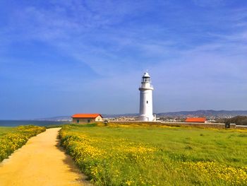 Beautiful landscape with lighthouse, road, grass and house