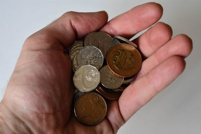 Close-up of hand holding coins