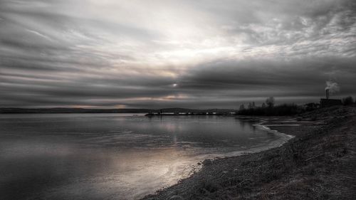 Scenic view of sea against cloudy sky