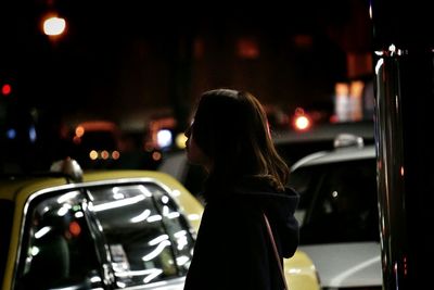 Woman standing at night