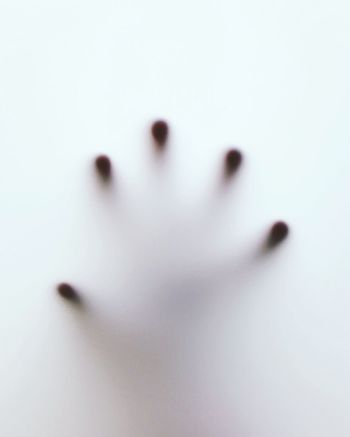 Close-up of human hand on condensed window