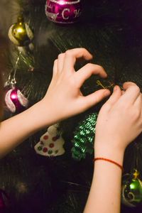 Midsection of woman holding christmas tree