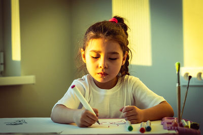 Portrait of cute girl studying at home