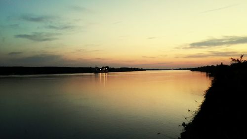 Scenic view of lake against sky during sunset