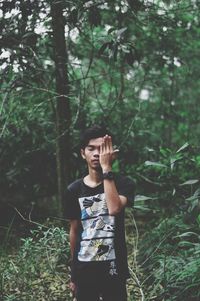 Full length of woman standing in forest