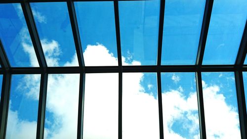 Low angle view of blue sky seen through window