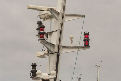 Low angle view of telephone pole against sky