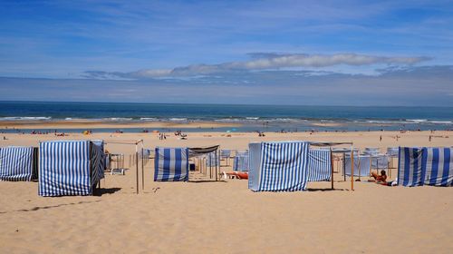 Scenic view of beach against blue sky