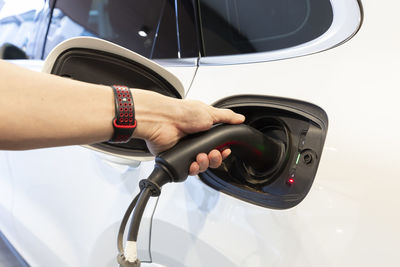 Cropped hand of man washing car