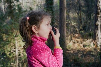 Girl with radio set in forest