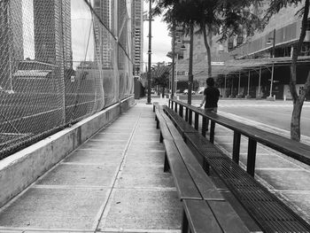 Man in city against sky