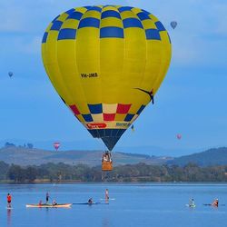 Hot air balloons flying over sea