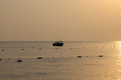Scenic view of sea against clear sky during sunset