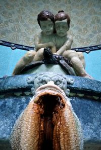 Low angle view of statue against fountain