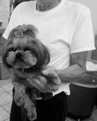 Midsection of woman holding dog